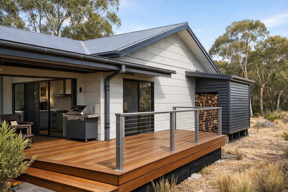 House exterior with deck corners and gutters designed to reduce ember traps
